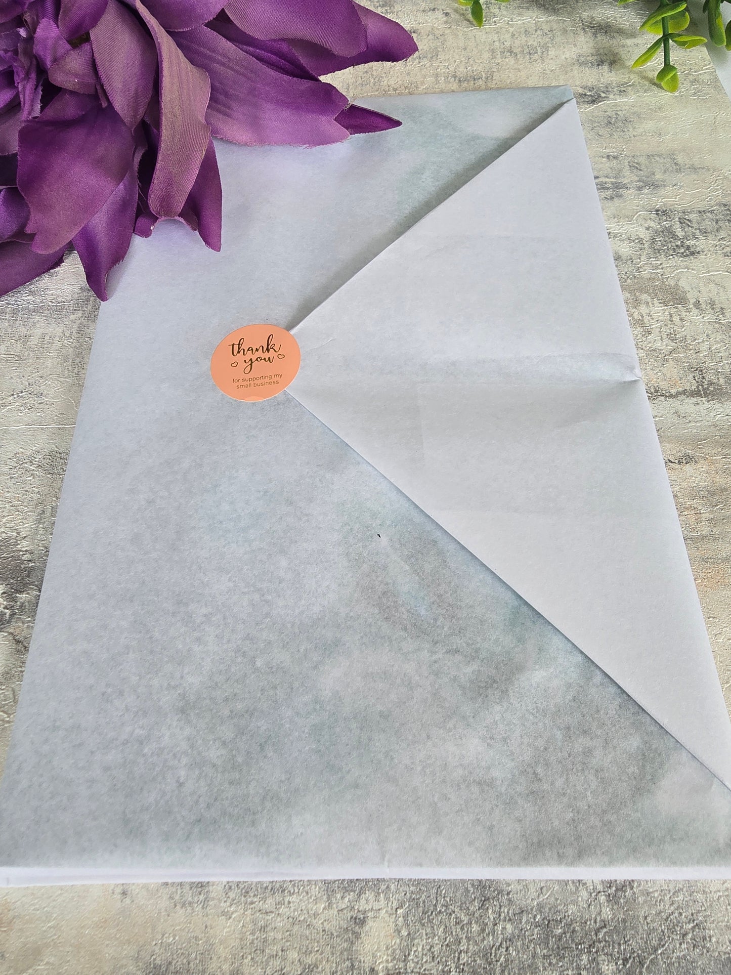 A5 notebook beautifully packaged in crisp white tissue paper with thank you sticker.